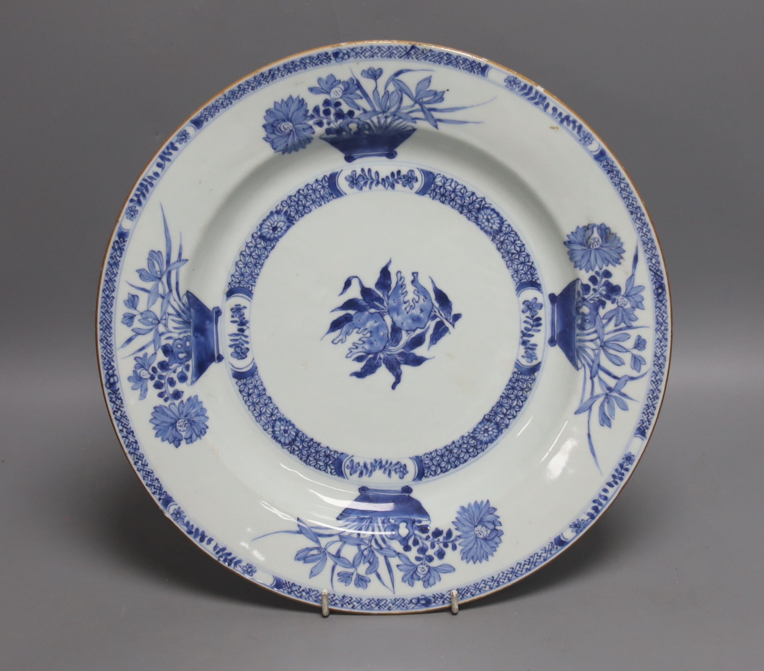 An 18th century Chinese blue and white circular dish decorated with flowering plants, Dia 32.5cm